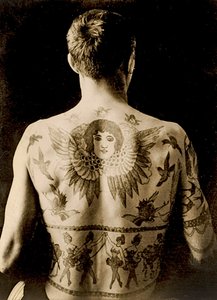 Portrait of a Man with an Elaborate Back-Piece Tattoo, c.1910